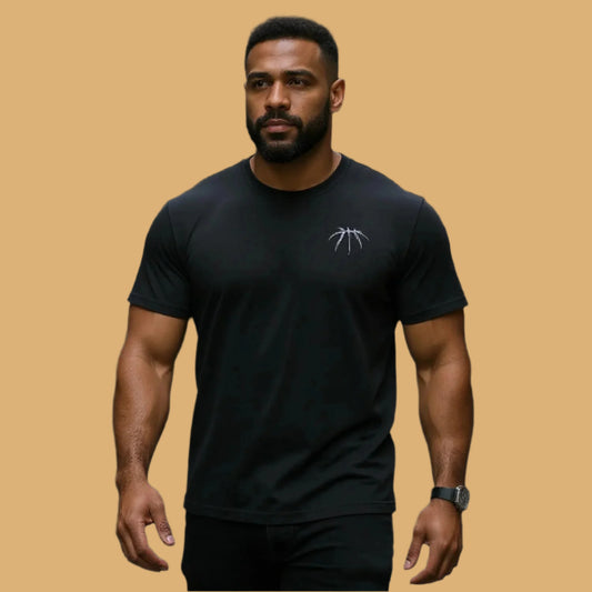 Man wearing a black t-shirt with a logo on a beige background