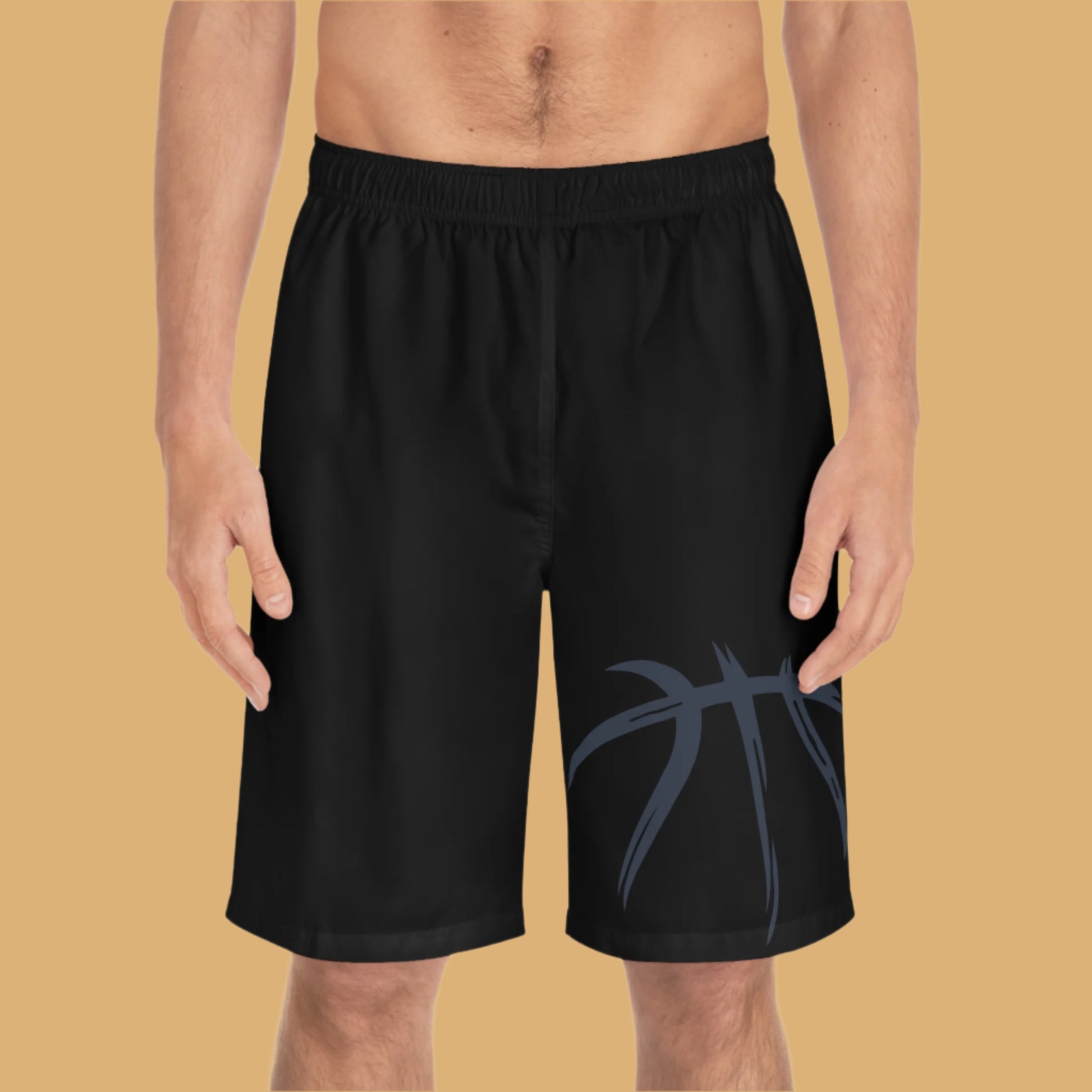 Black shorts with a blue design on a beige background