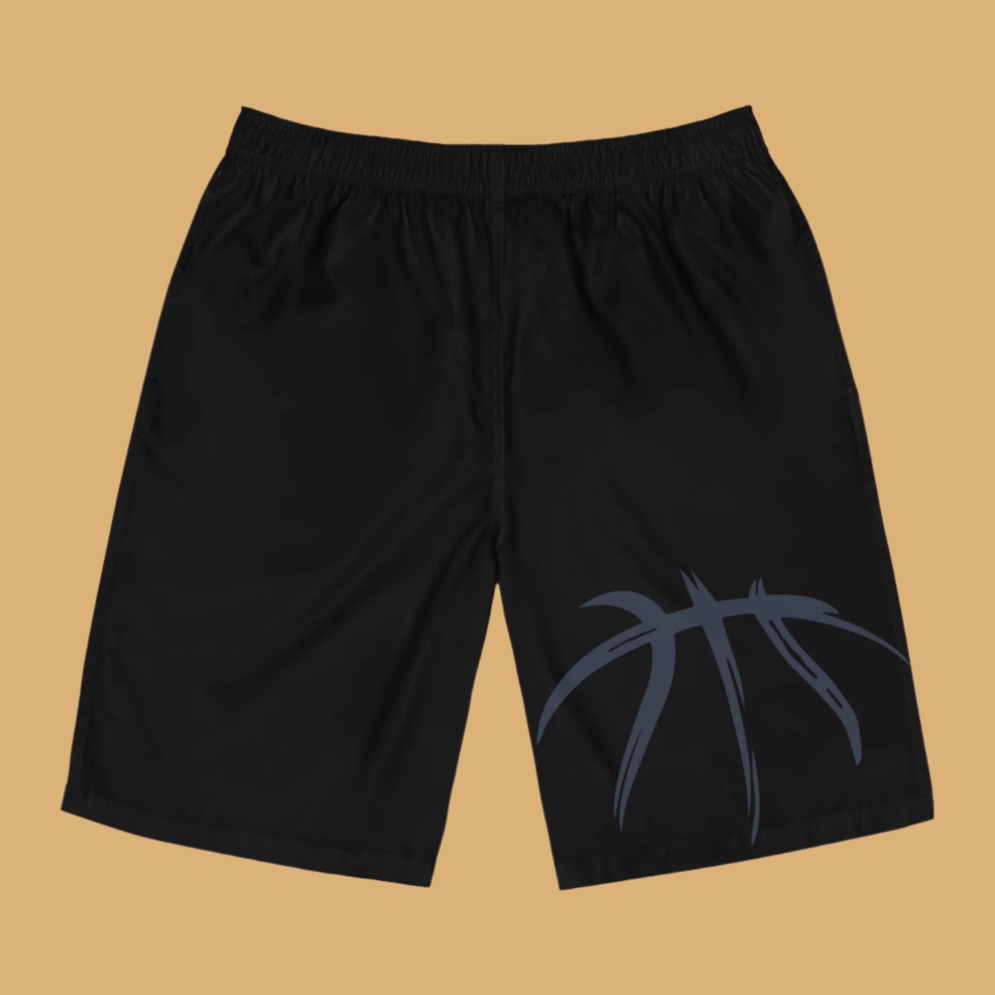 Black shorts with a blue basketball design on a beige background