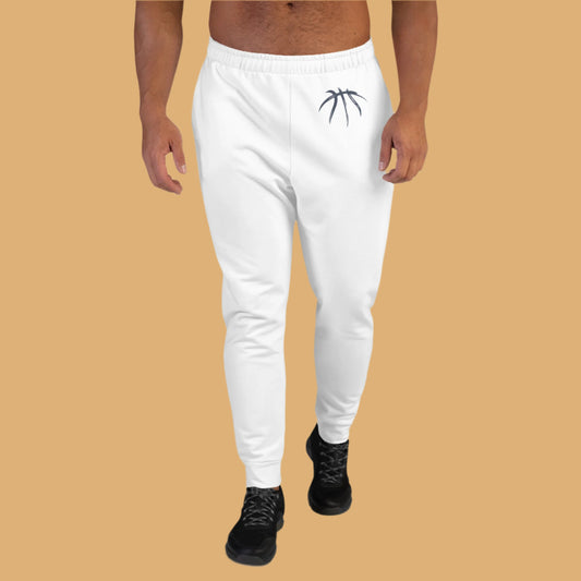 White sweatpants with a black logo worn by a person on a beige background