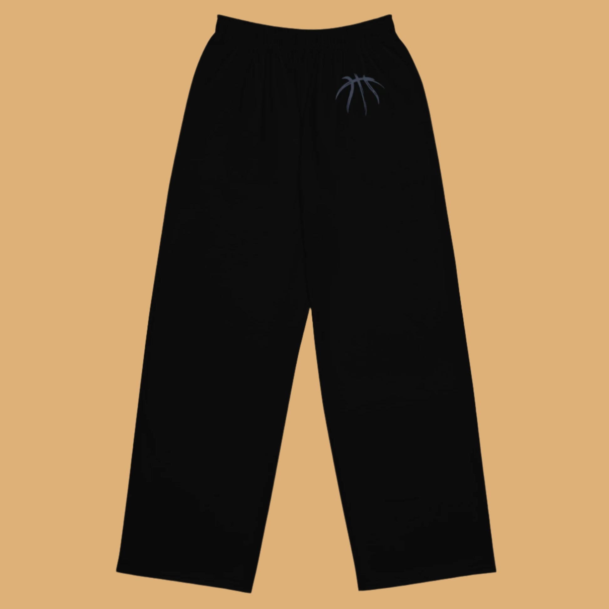 Black pants with a small logo on a beige background