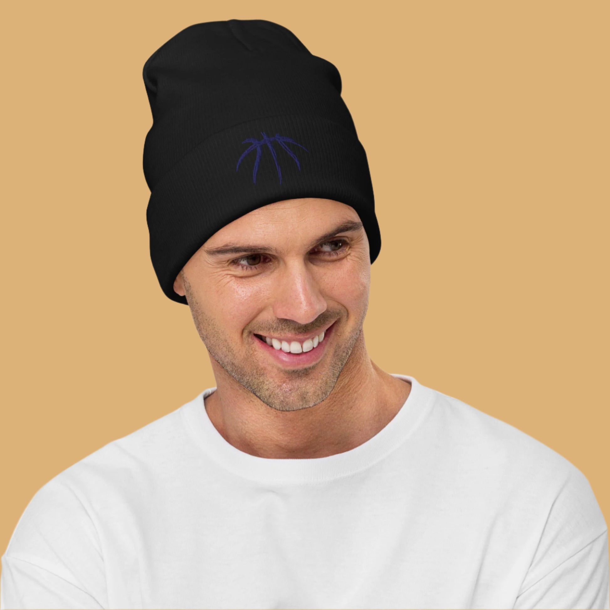 Man wearing a black beanie with a logo on a white background
