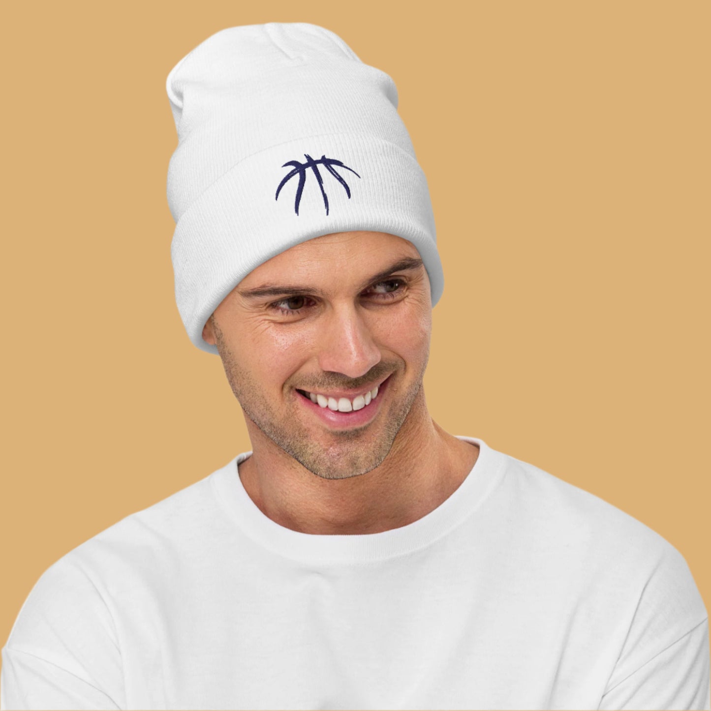Man wearing a white beanie with a blue logo on a white background