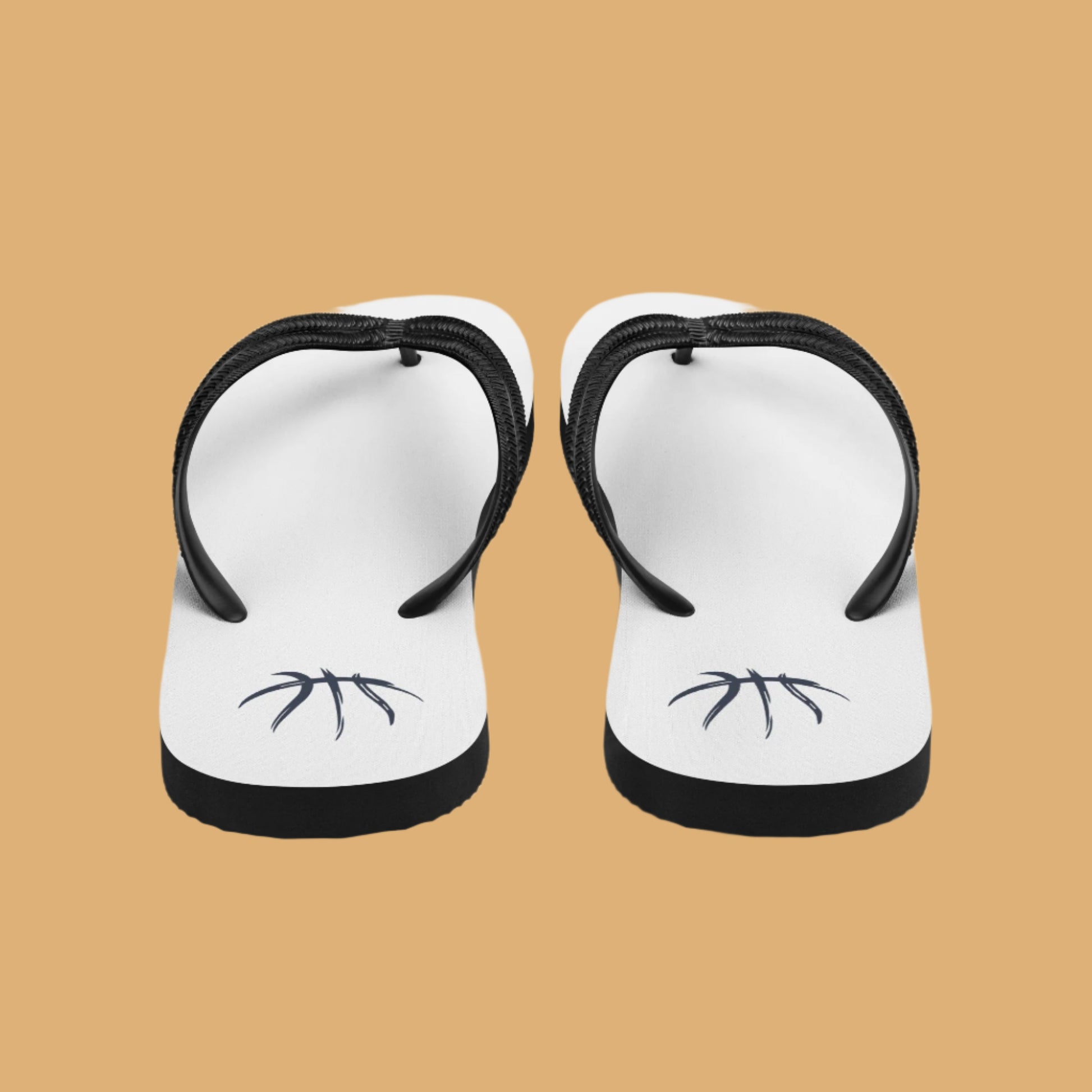 Pair of white flip-flops with black straps on a white background