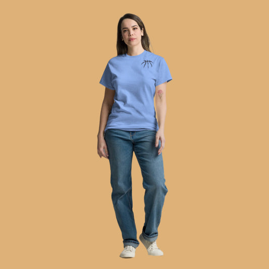 Person wearing a blue t-shirt and jeans on a beige background