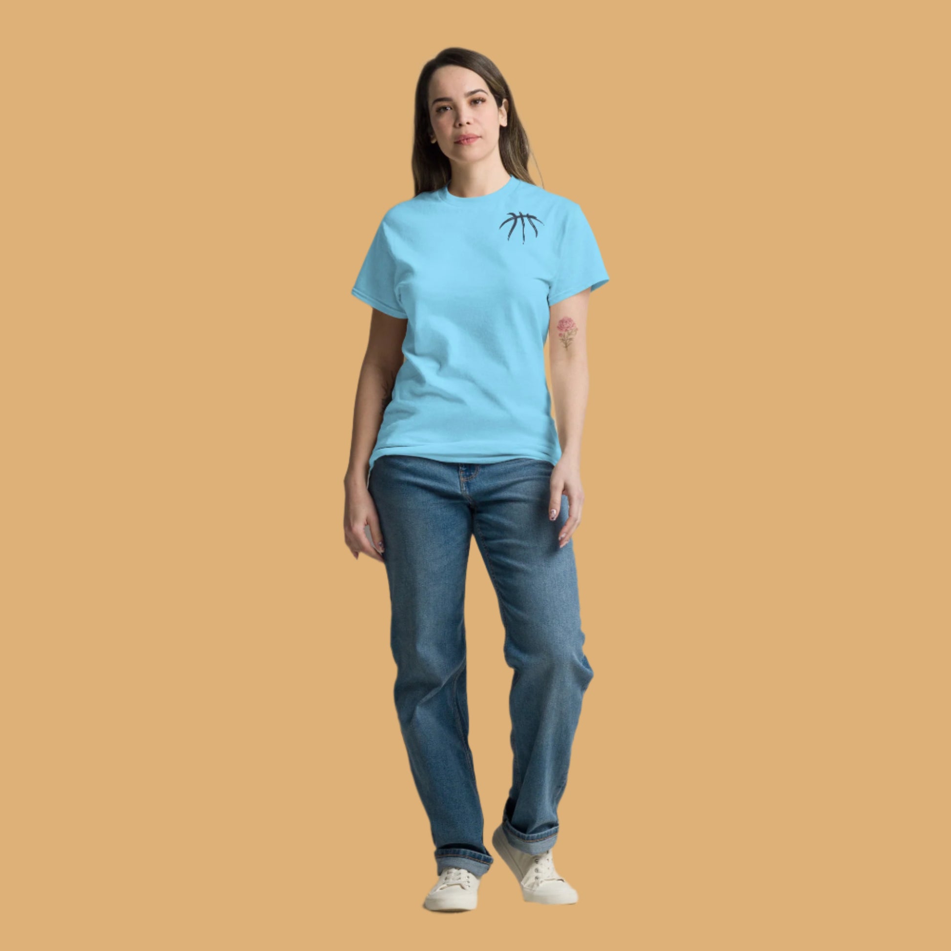 Person wearing a light blue t-shirt and jeans on a beige background