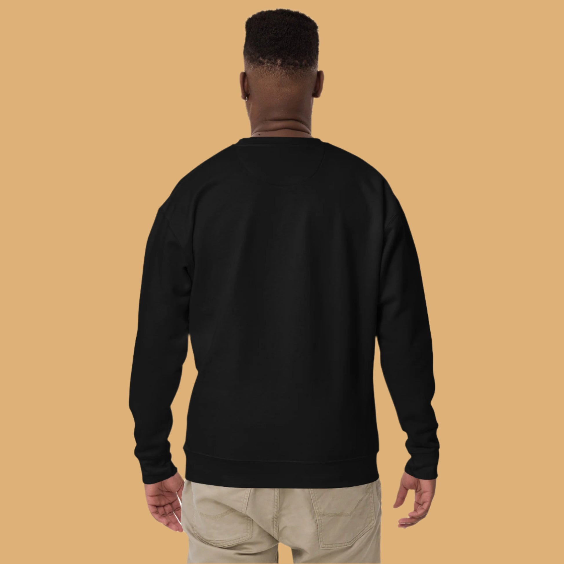 Person wearing a black sweatshirt on a white background