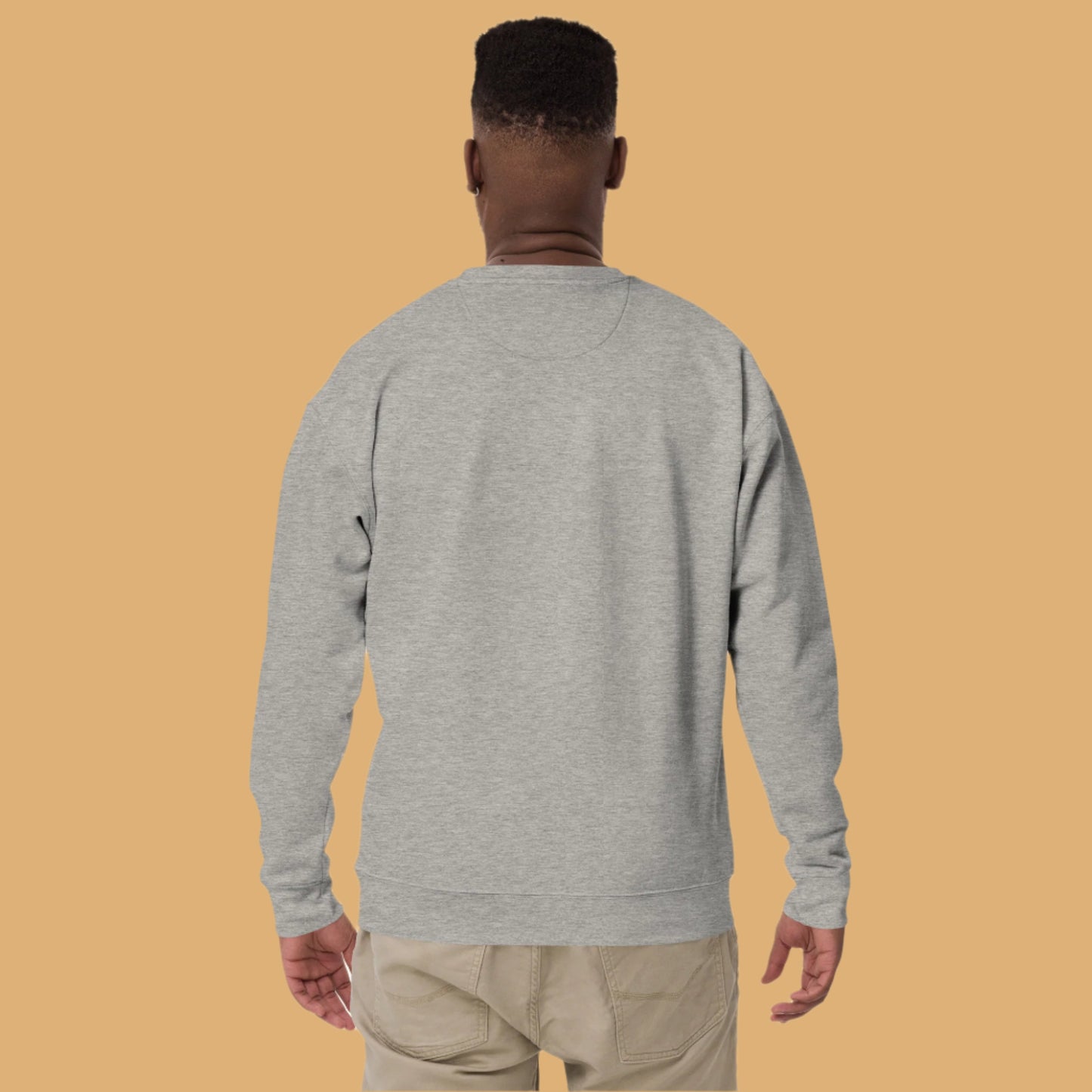 Person wearing a gray sweatshirt on a white background