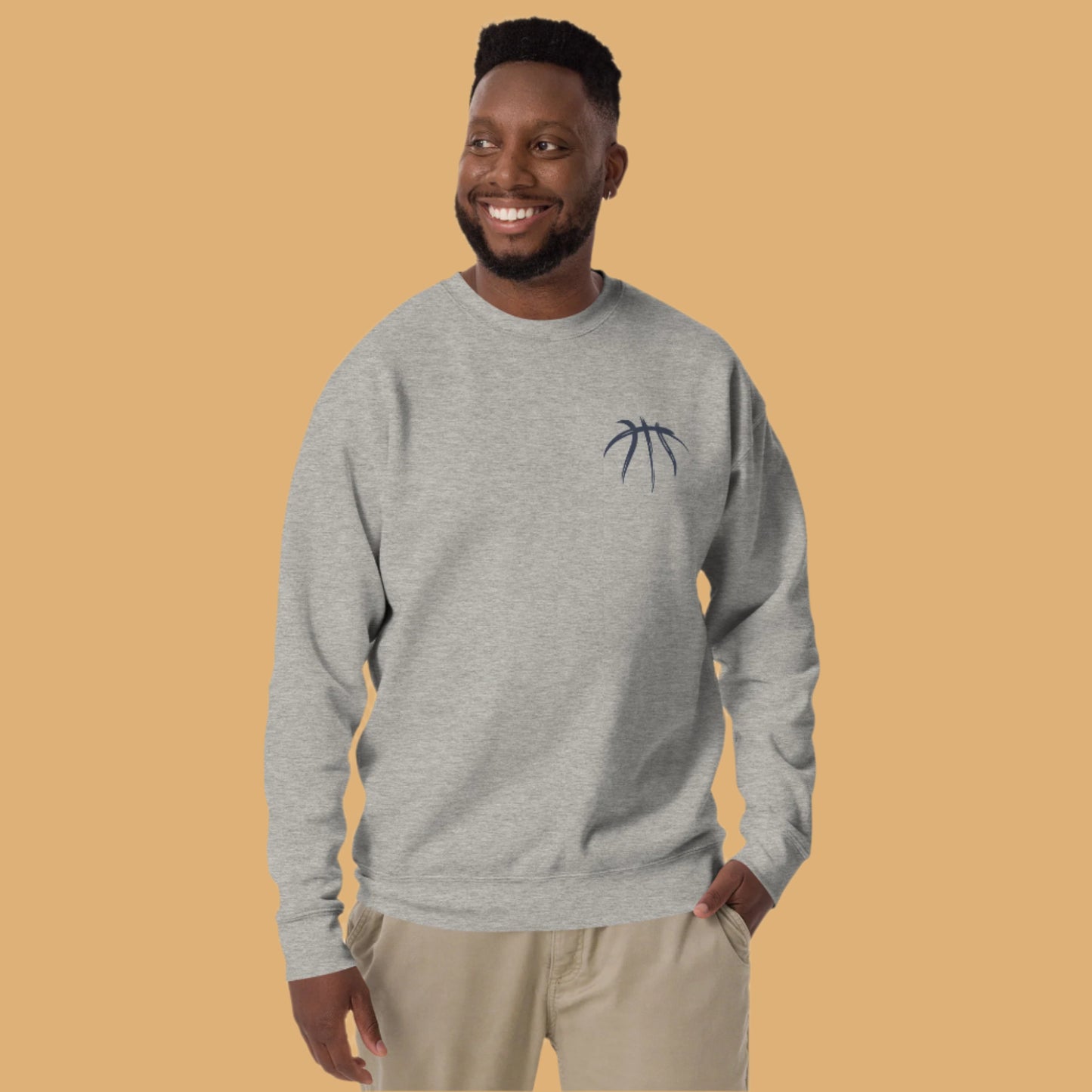 Man wearing a gray sweatshirt with a small logo on a white background
