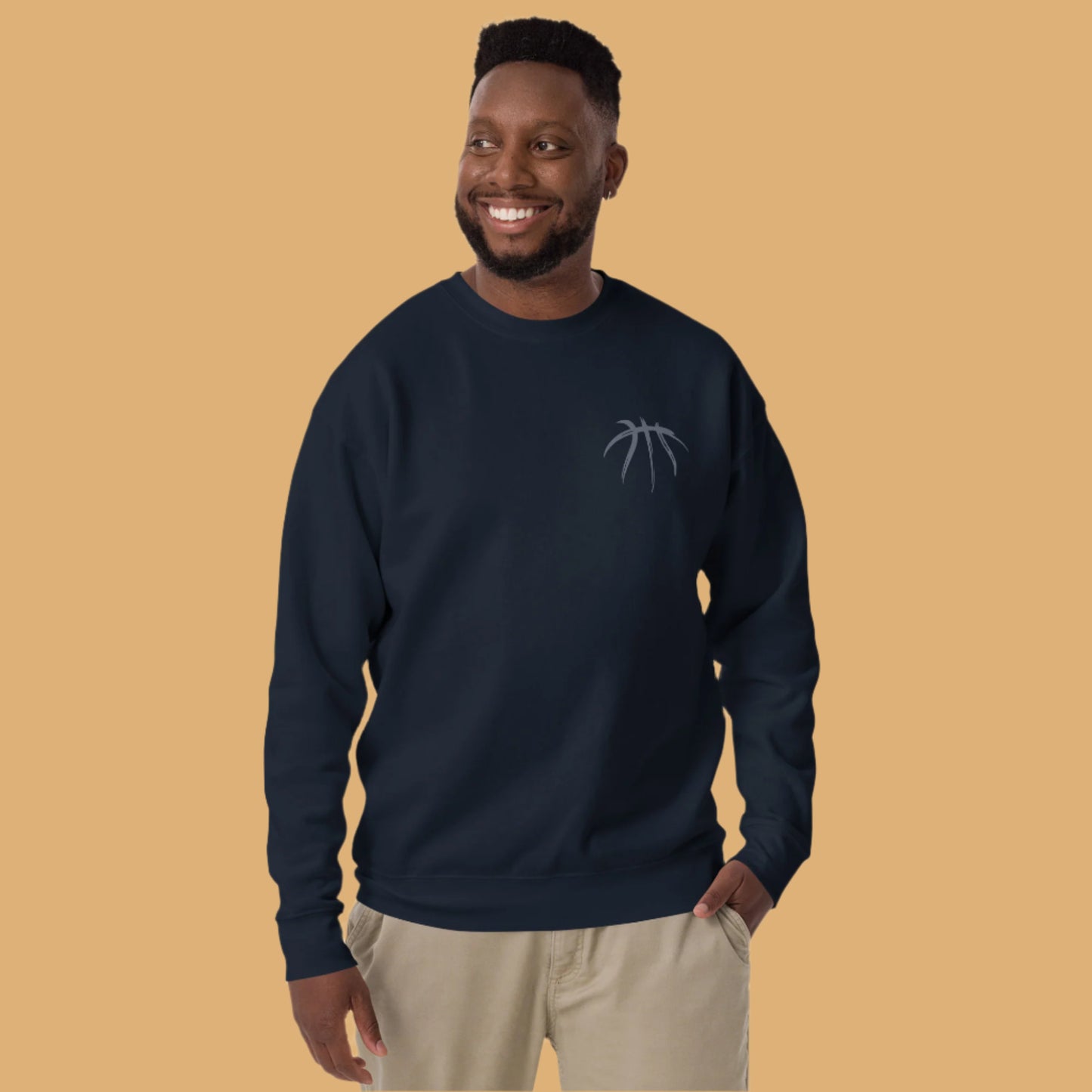 Man wearing a navy blue sweatshirt with a logo on a white background