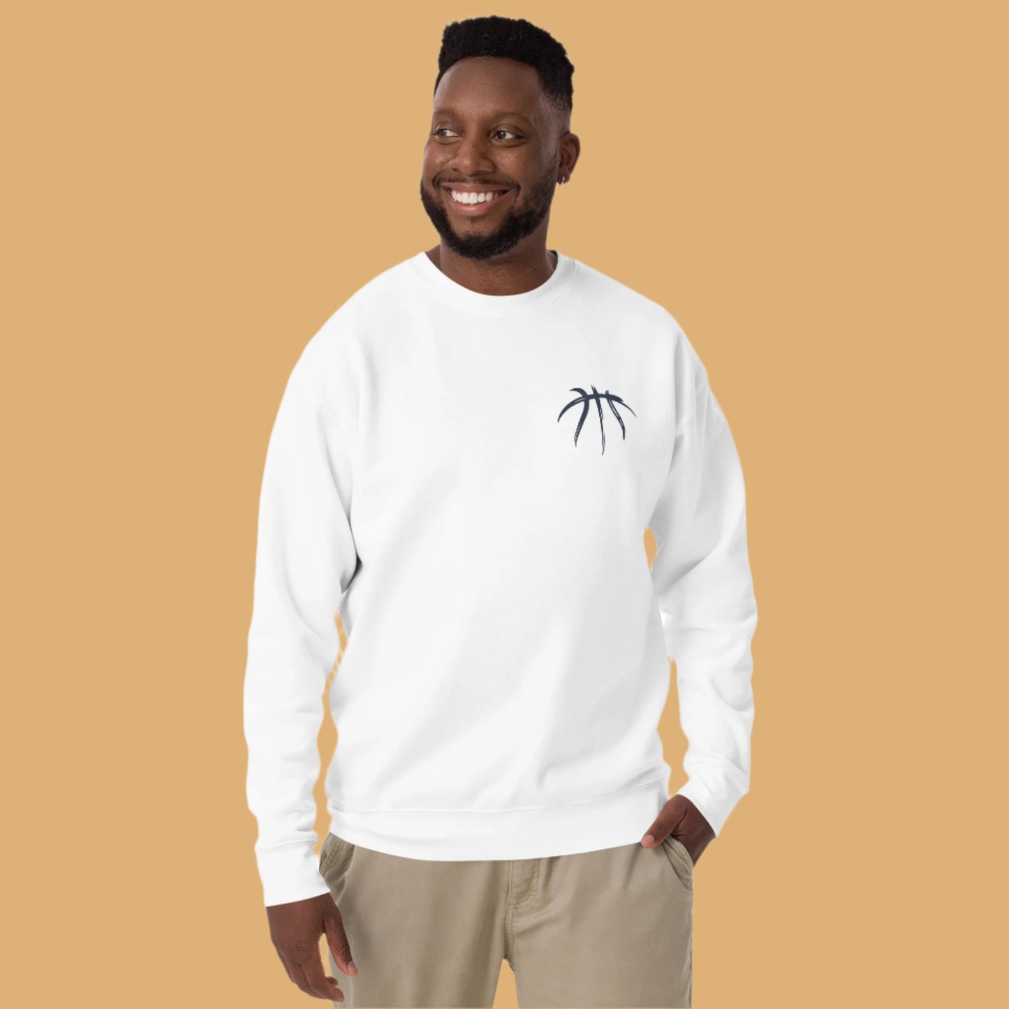 Man wearing a white sweatshirt with a black logo on a beige background