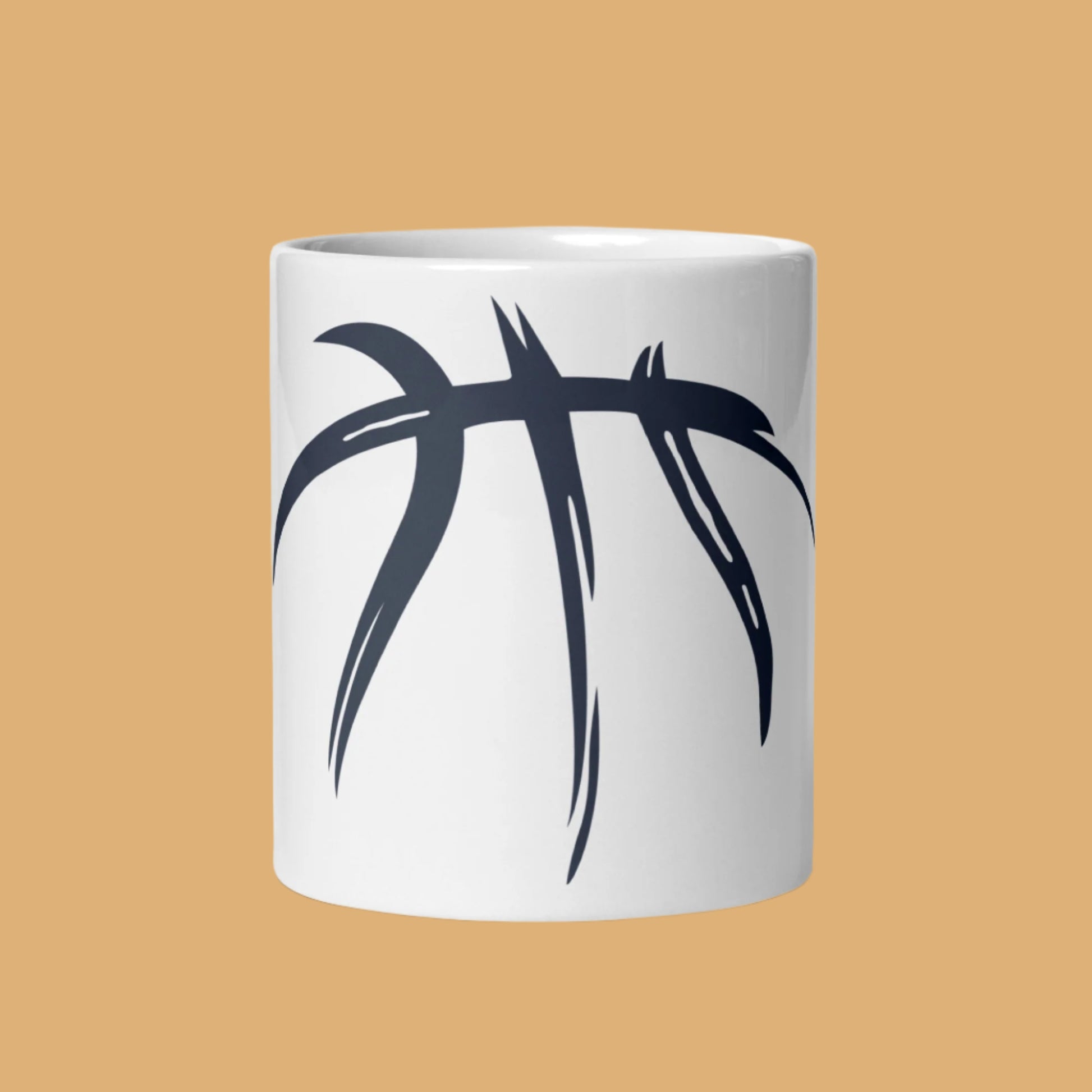 White mug with black abstract design on a beige background