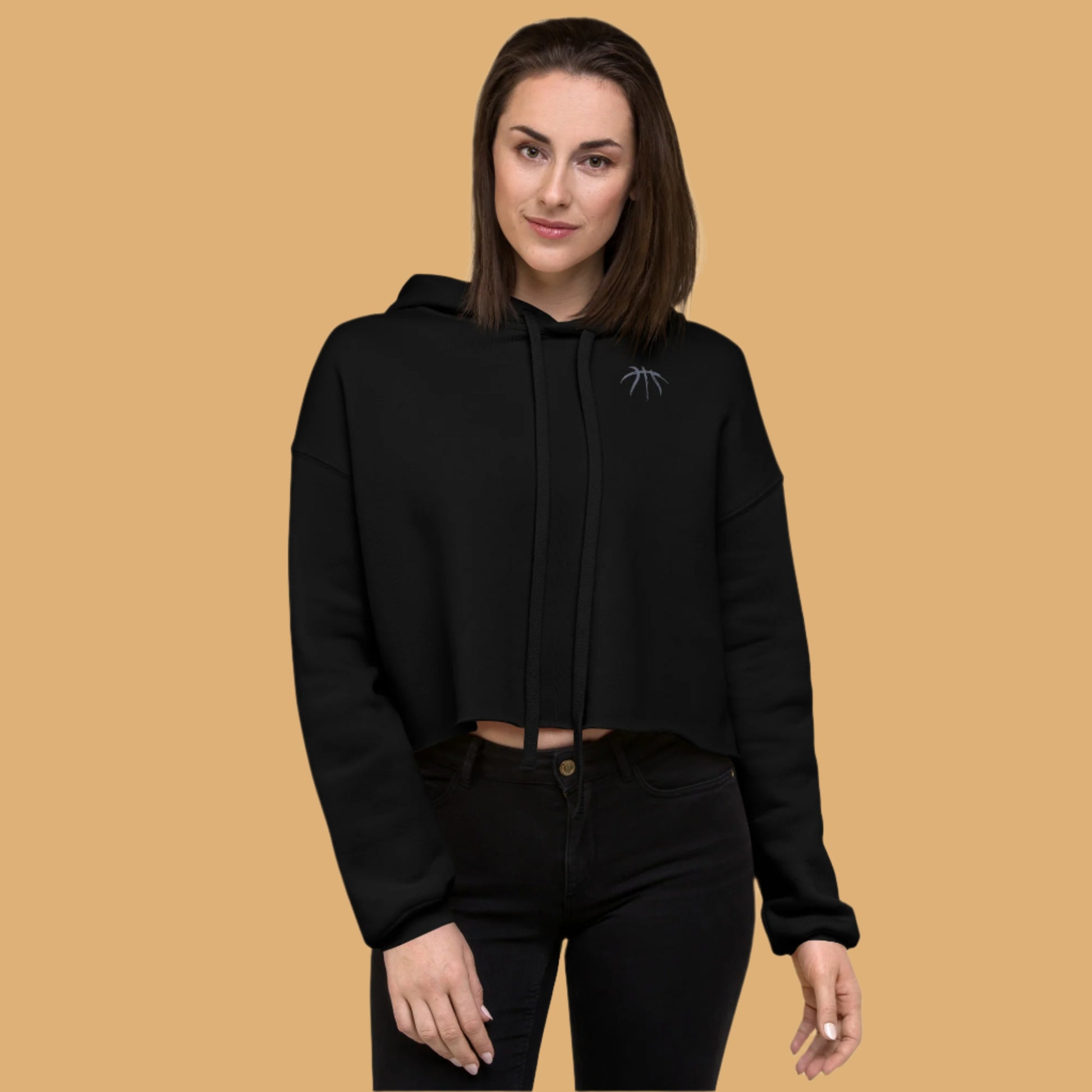 Woman wearing a black hoodie with a logo on a white background
