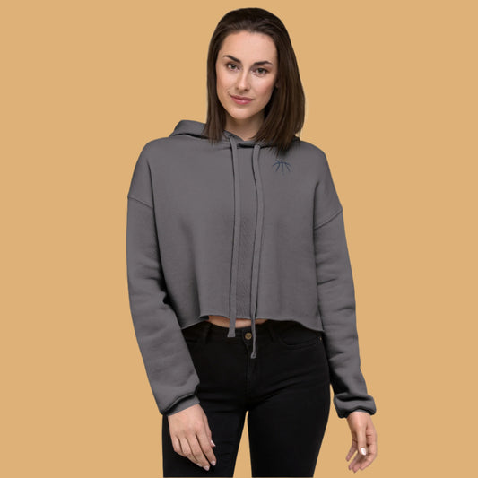Woman wearing a gray hoodie on a beige background